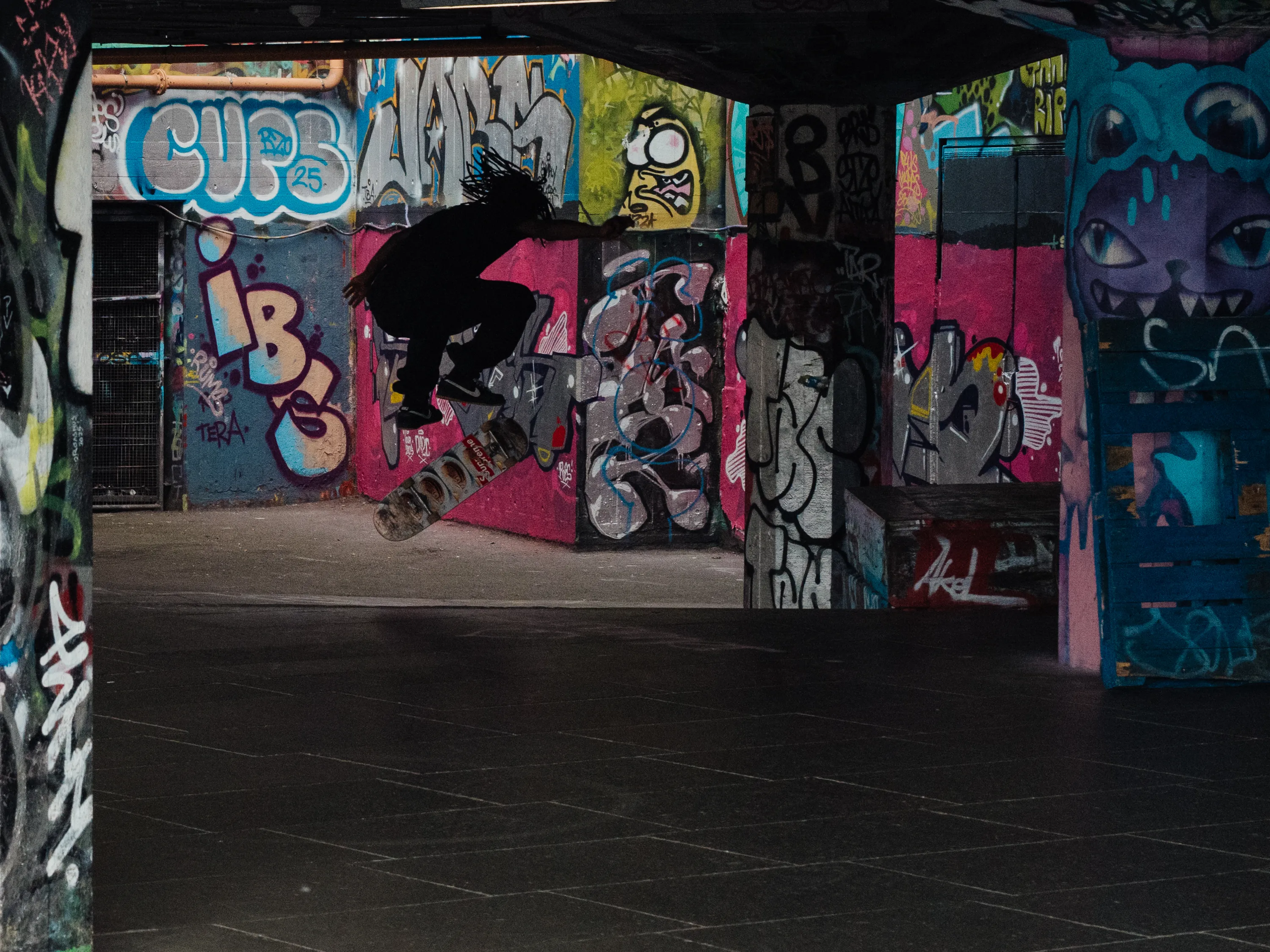 A man in mid-air attempts to land a skateboarding trick