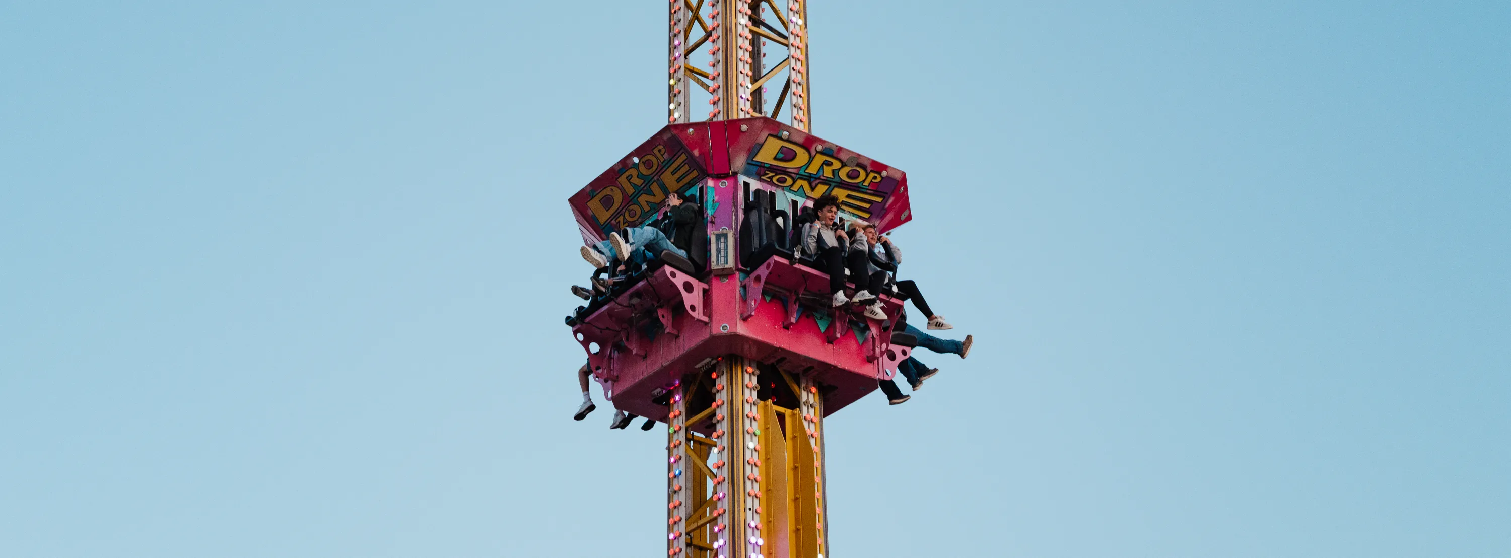 A picture of teenagers mid-air on a fair ride