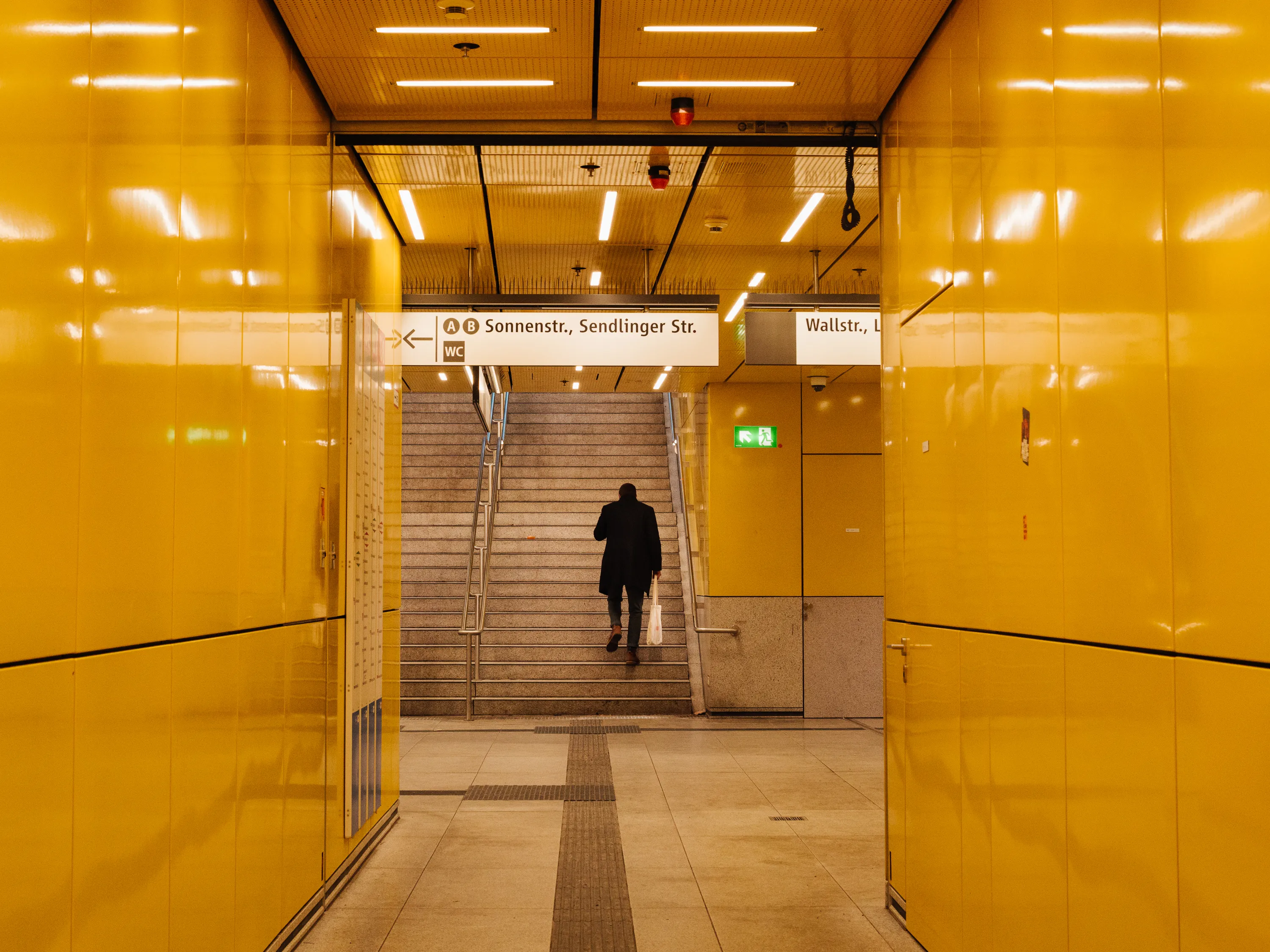 A man walks up out of a subway station